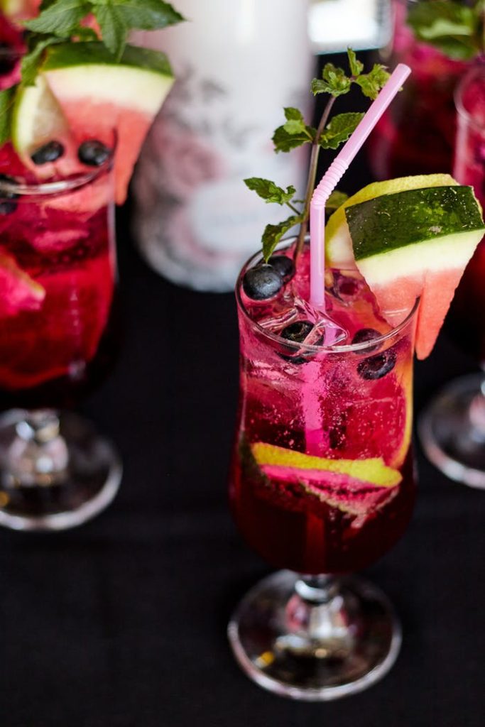 EnYe Bar Refreshing summer cocktails with watermelon and blueberry garnishes, perfect for parties and gatherings.