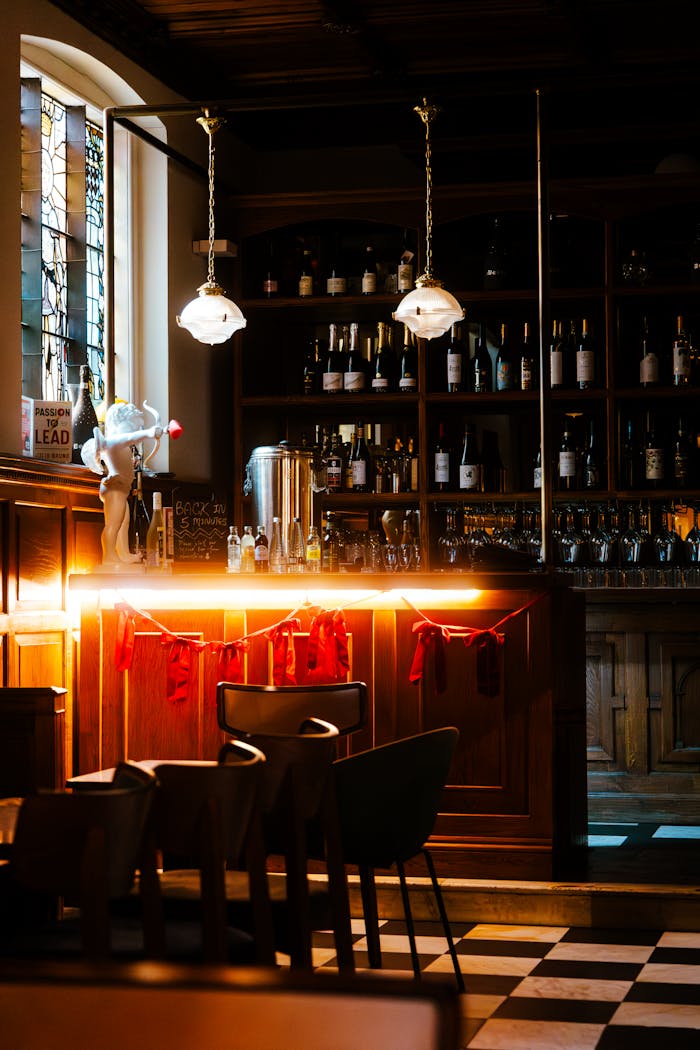 Moody bar interior in London featuring warm lighting and vintage decor.